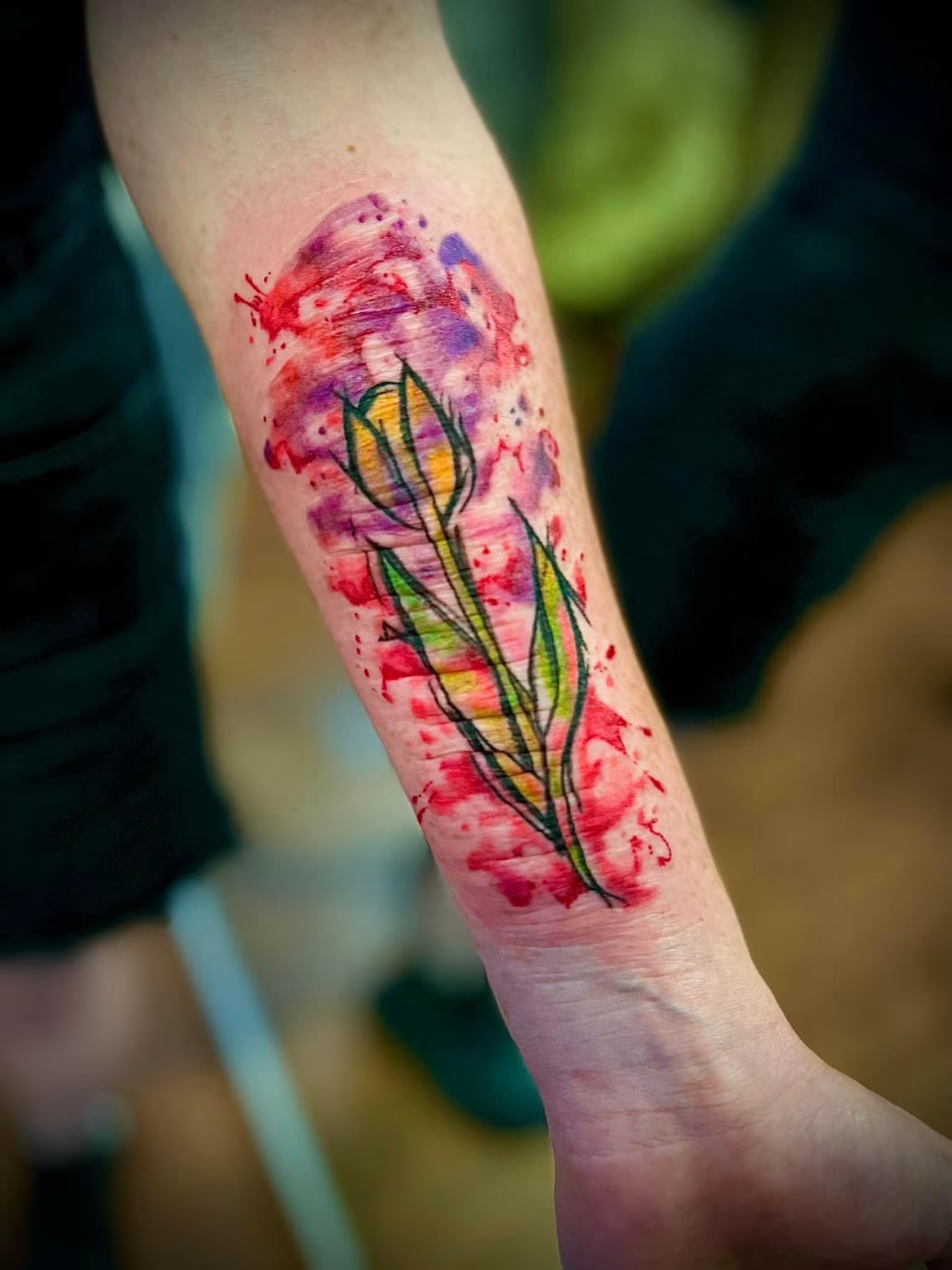 Colorful floral tattoo on a forearm after tattooing