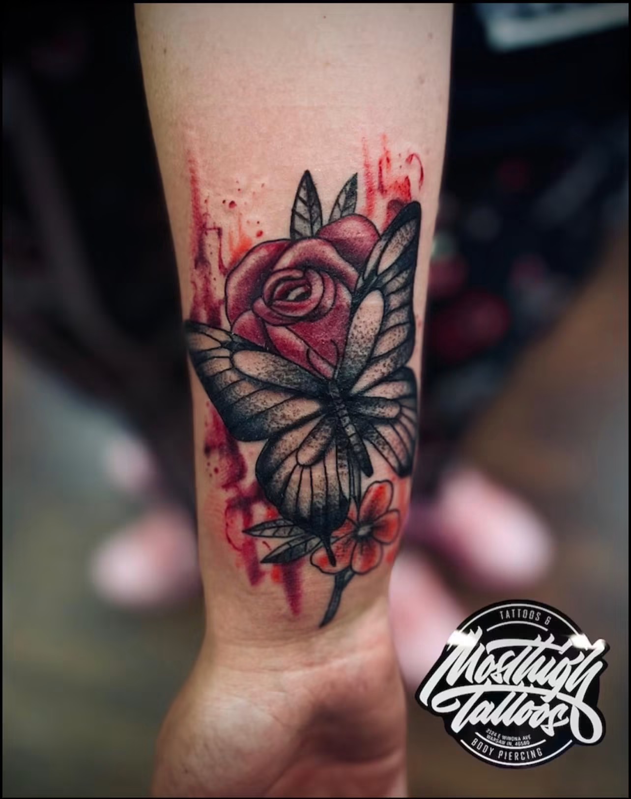 Rose and butterfly tattoo on a forearm after tattooing